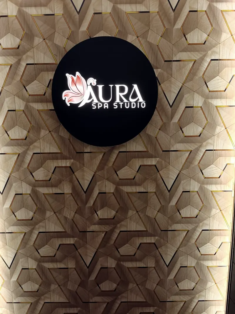 Aura Spa Studio logo on the studio wall