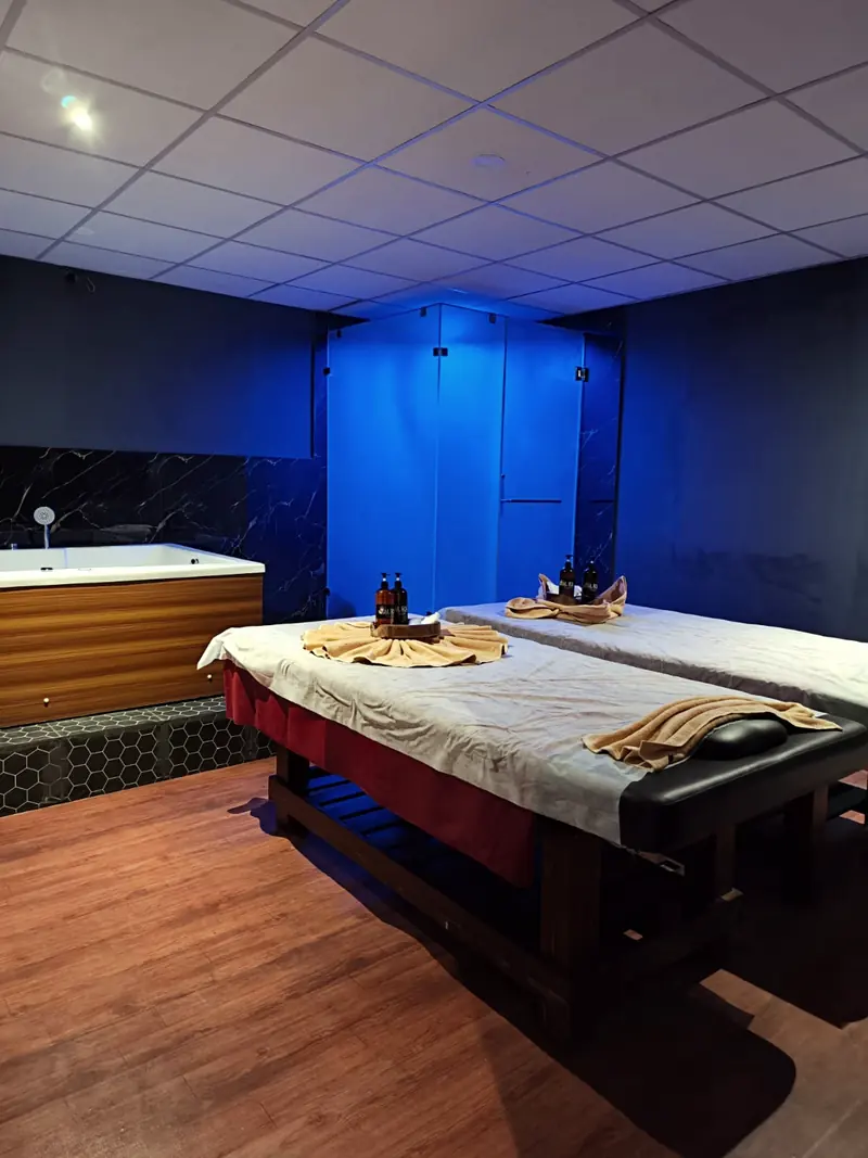 Aura couple suite with two massage beds and a Jacuzzi tub